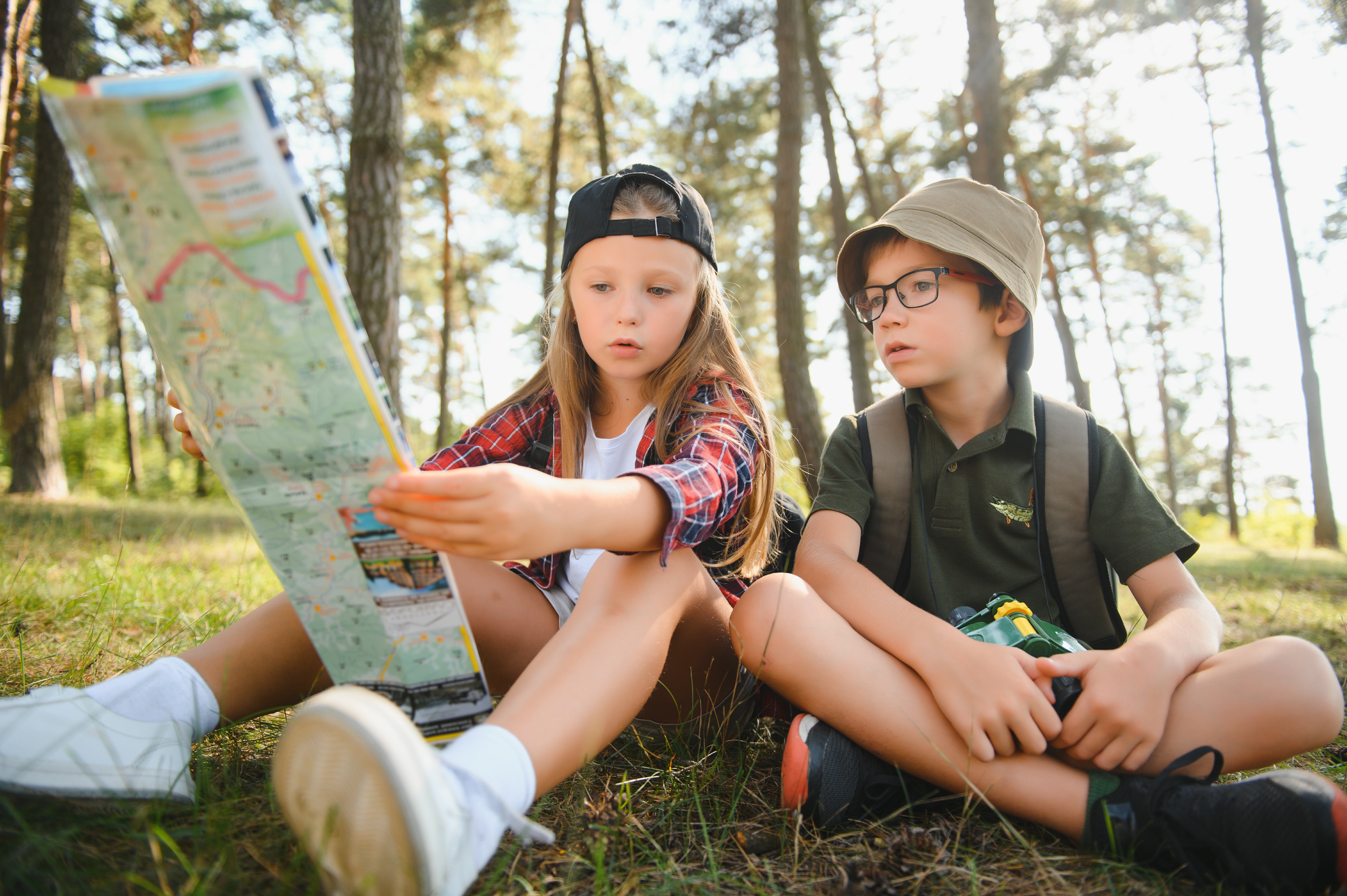 two-happy-children-having-fun-during-forest-hike-beautiful-day-pine-forest-cute-boy-scout-with-binoculars-during-hiking-summer-forest-concepts-adventure-scouting-hiking-tourism